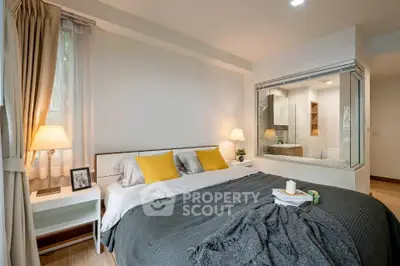 Spacious modern bedroom with large window and cozy decor, featuring a view into the ensuite bathroom.