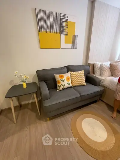Cozy living room with modern gray sofa, stylish decor, and wooden flooring