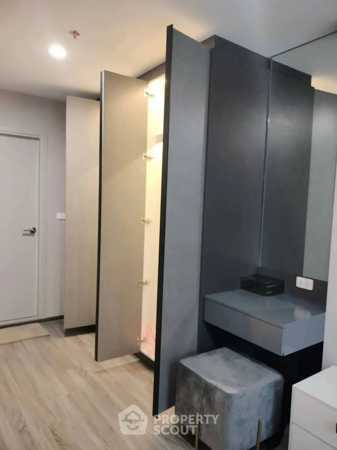 Modern bedroom with sleek wardrobe and stylish vanity area