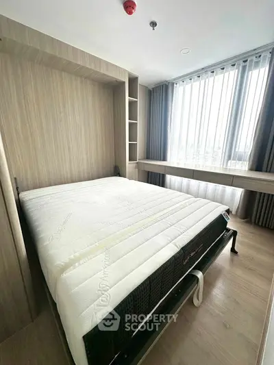 Modern bedroom with large window and stylish wooden furnishings