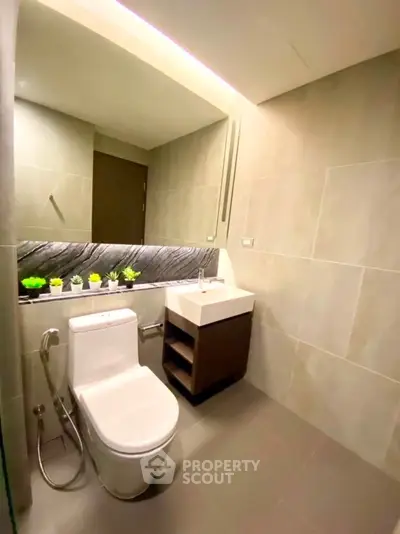 Modern bathroom with sleek design and elegant fixtures in a contemporary real estate property.