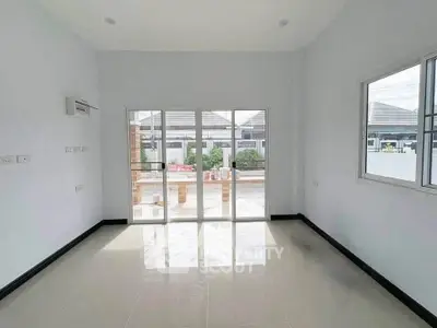 Spacious empty room with large windows and garden view, perfect for customization.