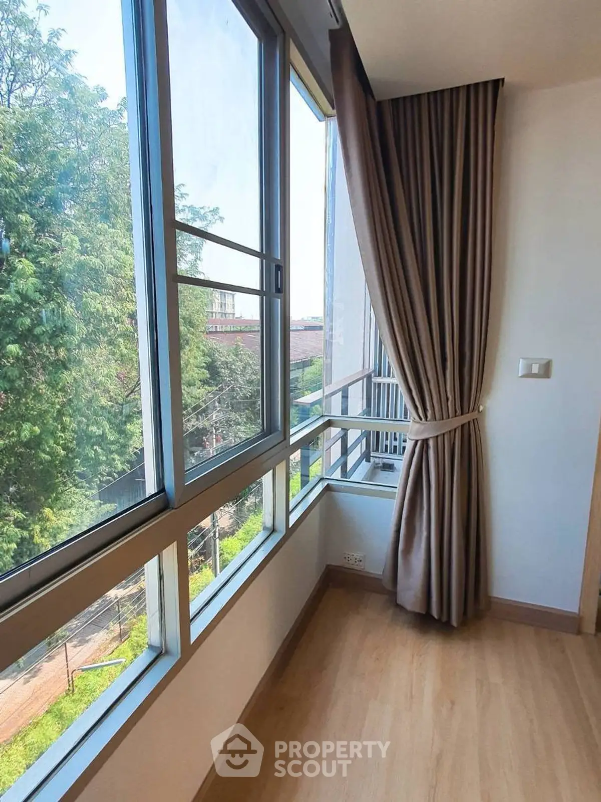 Bright corner unit with large windows offering a stunning view of lush greenery, perfect for nature lovers.