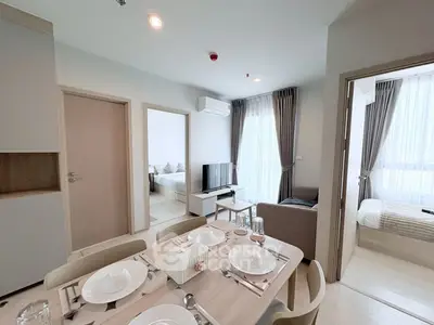 Modern apartment interior with dining area and cozy living room