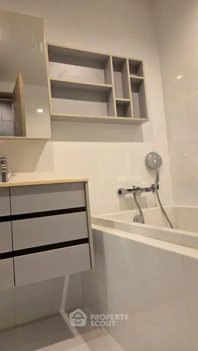 Modern bathroom with sleek fixtures and built-in storage solutions.