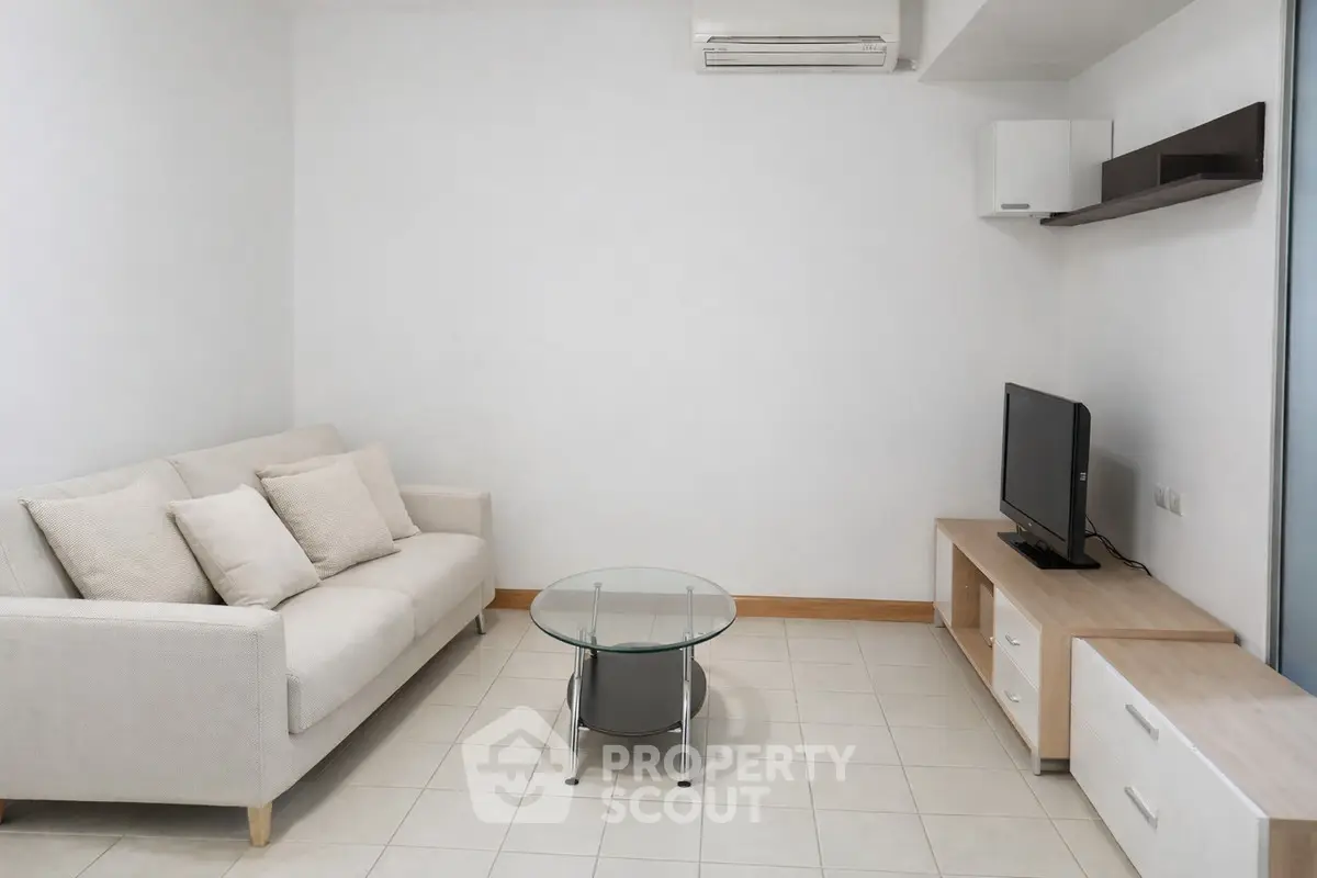 Modern minimalist living room with cozy sofa and sleek TV setup