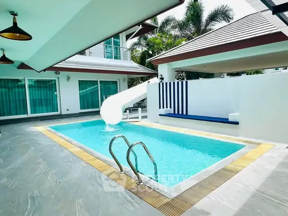 Luxurious private pool with slide in modern villa, perfect for family fun and relaxation.