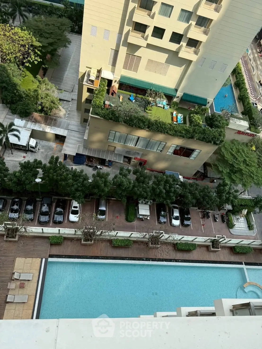 Stunning aerial view of luxury apartment complex with pool and garden terrace