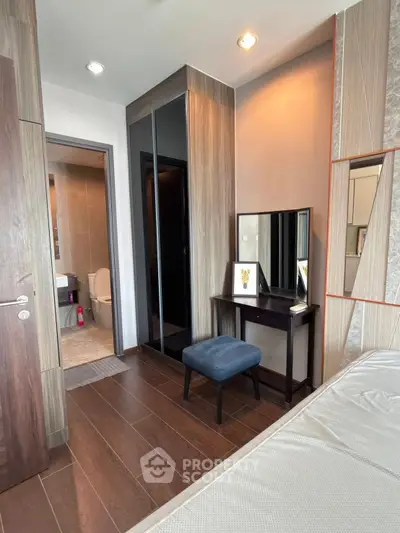 Modern bedroom with ensuite bathroom and stylish wooden flooring