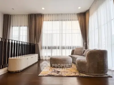 Elegant living room with modern furniture and large windows for natural light.