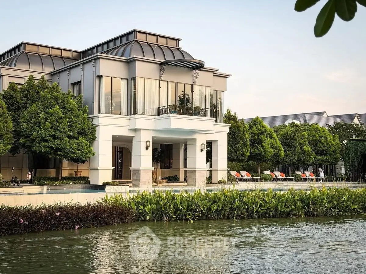 Luxurious waterfront property with modern architecture and lush greenery