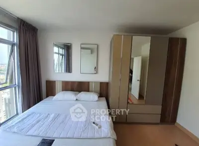 Modern bedroom with large window and stylish wardrobe