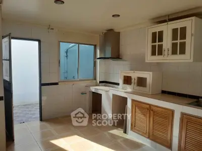 Spacious kitchen with ample natural light and modern cabinetry, perfect for culinary enthusiasts.