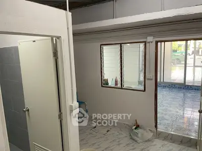 Simple interior with tiled floor and bathroom entrance