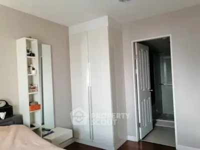 Modern bedroom with sleek white wardrobe and ensuite bathroom