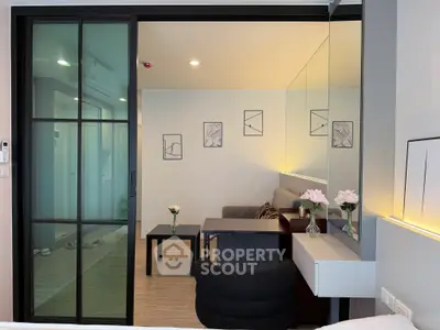 Modern living room with stylish decor and sliding glass doors in a contemporary apartment.