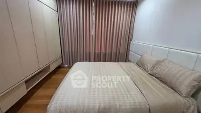 Cozy bedroom with elegant curtains and spacious wardrobe in modern apartment.