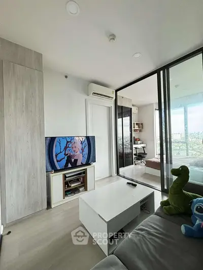 Modern living room with glass partition, cozy sofa, and city view, perfect for urban living.