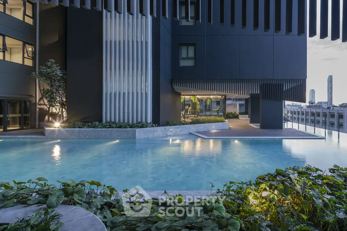 Luxurious modern building with stunning pool and city view, perfect for urban living.