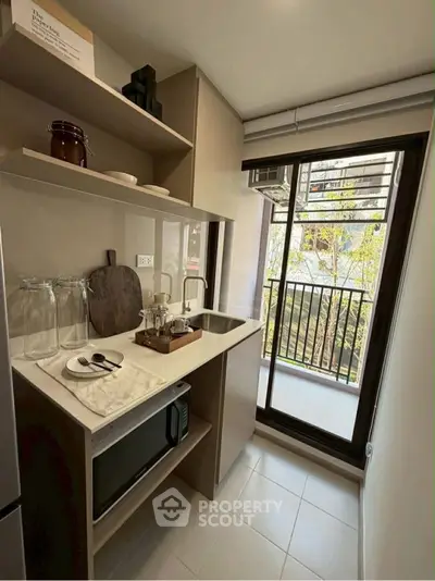 Modern kitchen with sleek design and open layout, featuring built-in appliances and stylish decor.