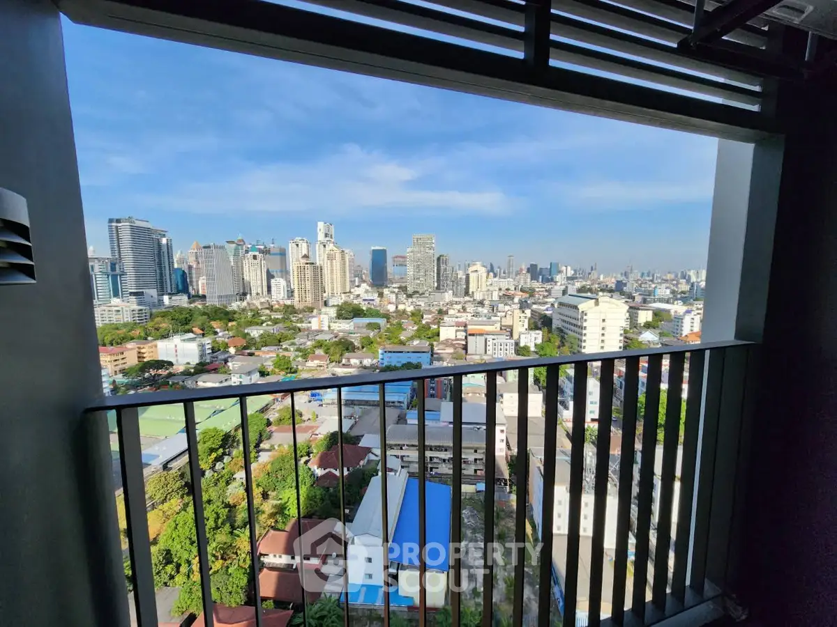 Stunning cityscape view from a high-rise balcony, showcasing urban skyline and vibrant city life.