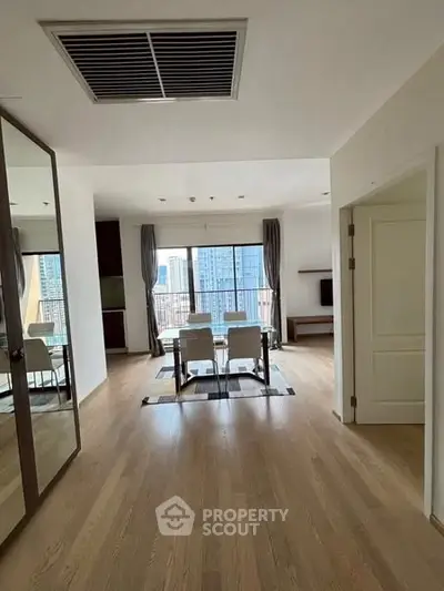 Spacious modern living room with city view and elegant dining area