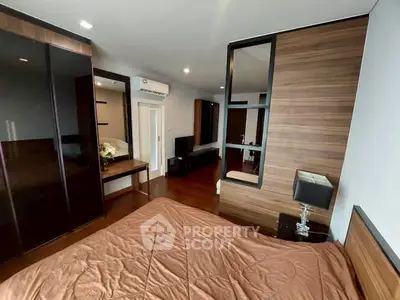 Modern bedroom with stylish wood paneling and sleek furniture design