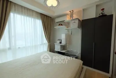 Cozy bedroom with large window and modern decor in a stylish apartment.