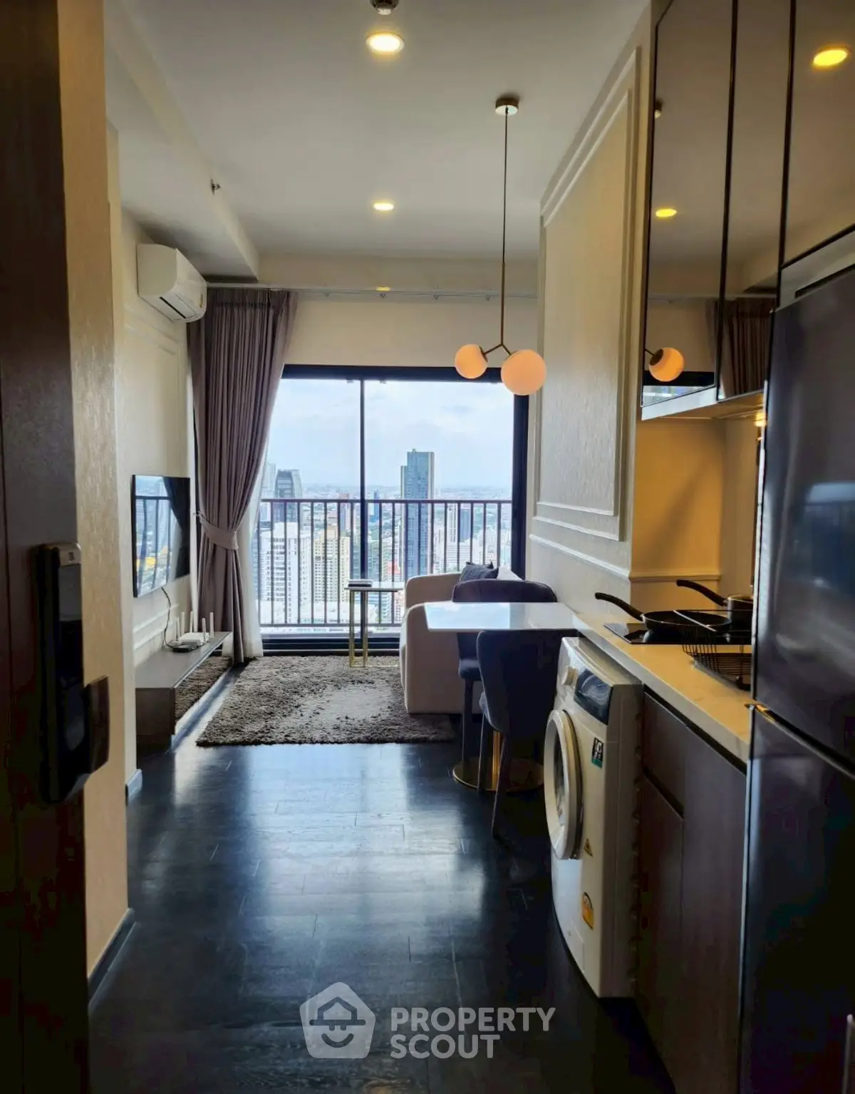 Modern apartment interior with city view, featuring open kitchen and cozy living area.