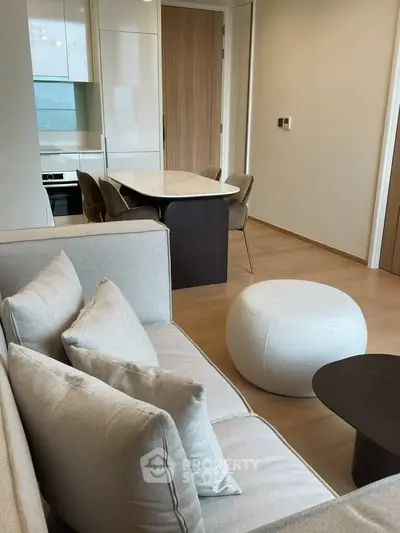 Modern living room with elegant furniture and open kitchen layout in a stylish apartment.