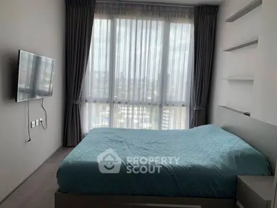 Modern bedroom with large window and wall-mounted TV, featuring elegant curtains and a cozy bed.