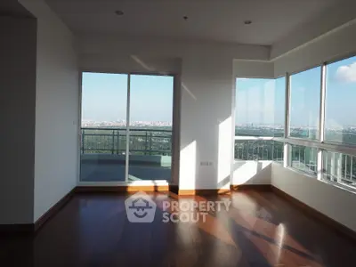 Spacious corner unit with panoramic city view and large balcony access.