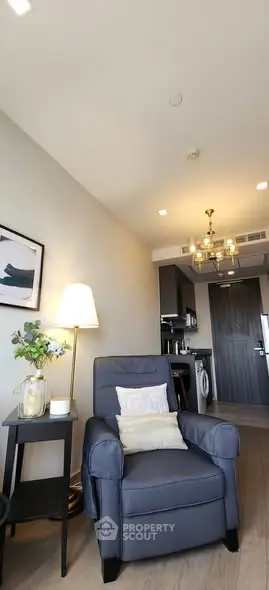 Modern living room with cozy armchair and stylish decor in a contemporary apartment.