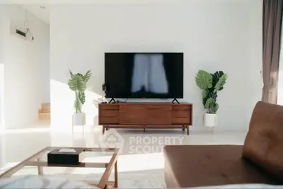Modern living room with sleek TV setup and stylish furniture