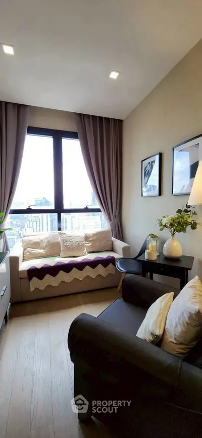 Cozy living room with city view, modern decor, and natural light.
