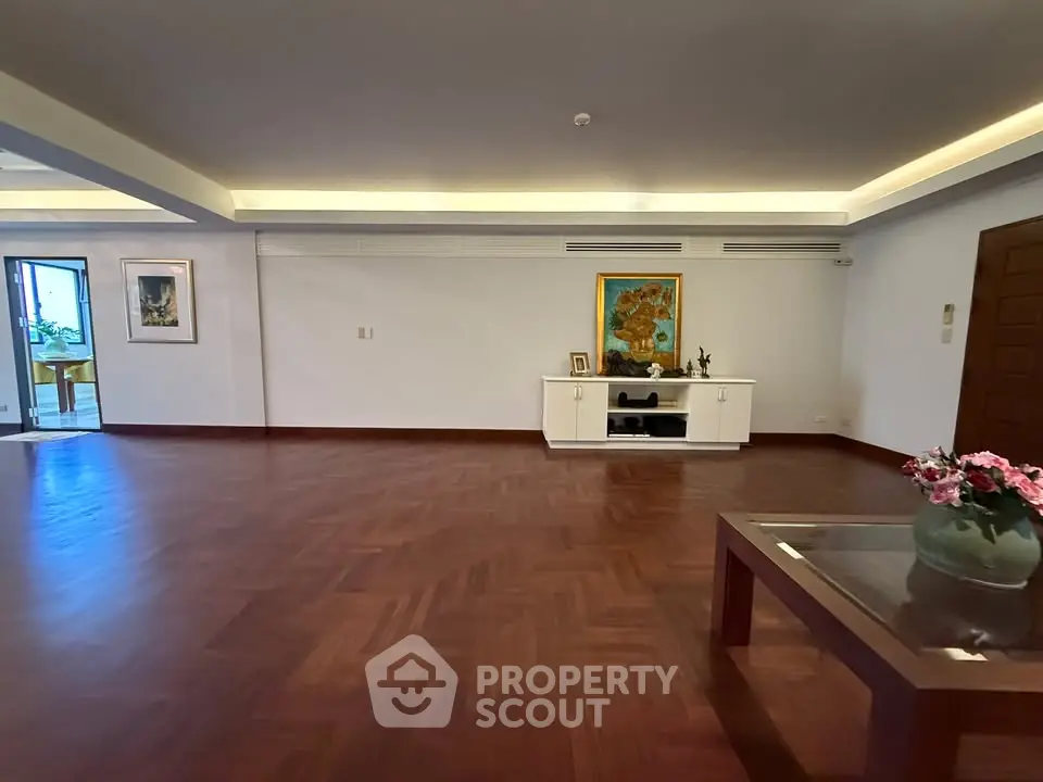 Spacious living room with elegant wooden flooring and modern decor