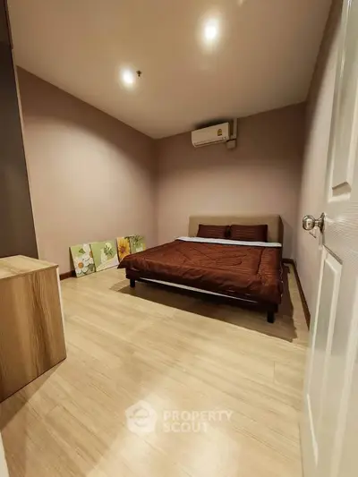 Cozy bedroom with modern decor and air conditioning in a stylish apartment.