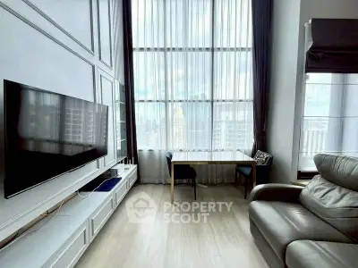 Luxurious high-ceiling living room with large windows and modern furnishings