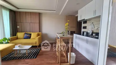 Modern open-layout living room with stylish kitchen and vibrant yellow sofa