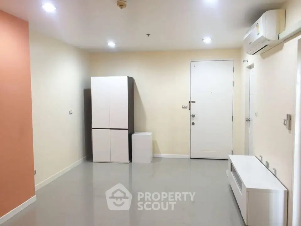 Spacious modern living room with minimalist design and ample natural light.