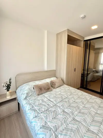 Modern bedroom with stylish decor and ample storage in a contemporary apartment.