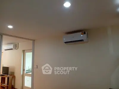 Modern living room with air conditioning and sliding glass doors for a comfortable lifestyle.