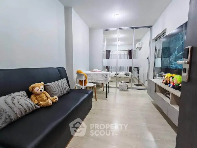 Cozy living room with modern decor and plush teddy bear on sofa