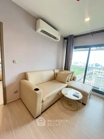 Modern living room with beige sofa and city view balcony