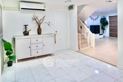 Spacious modern living area with elegant white cabinetry and stylish decor