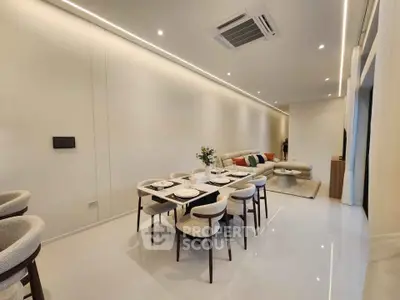 Luxurious open-plan living and dining area with modern furniture and elegant lighting.
