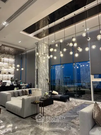 Luxurious modern living room with high ceilings, elegant lighting, and panoramic windows offering stunning views.