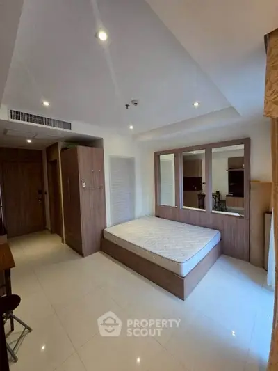 Spacious bedroom with modern design and ample natural light.