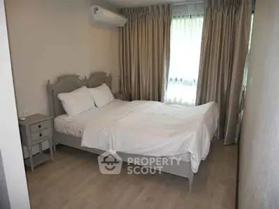 Cozy bedroom with elegant curtains and air conditioning in modern apartment.