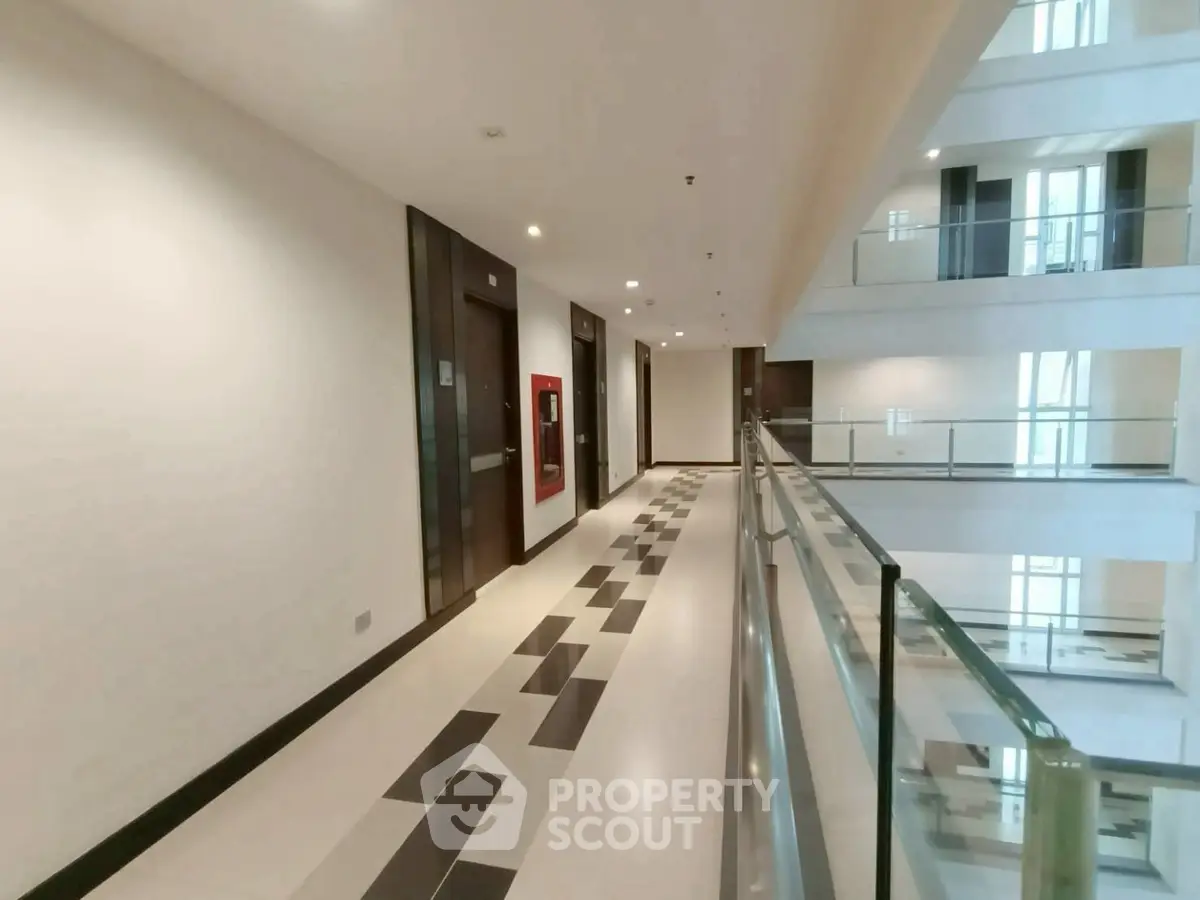 Modern apartment building corridor with sleek design and glass railings